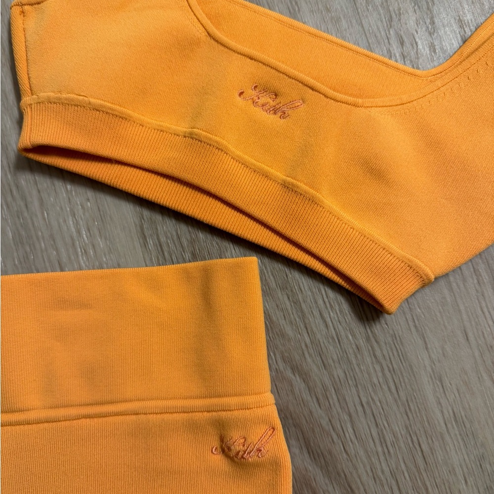 Kith orange workout set. Biker shorts and matching bra top.